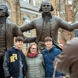 A mother poses with her children by the Washington and Jefferson statues.