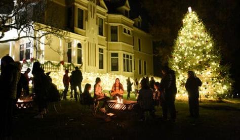 Students gather outside of the President's House during the annual tree lighting ceremony at Washington & Jefferson College.
